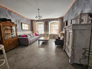 a living room with a couch and a table at Apartament mała Wenecja in Kowary