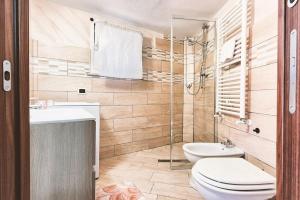 a bathroom with a toilet and a sink and a shower at Studio apartment in Rome with a pool in Colonna +13 photos