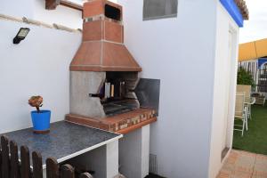 a outdoor pizza oven on the side of a house at LOS TOCHOS in Chiclana de la Frontera