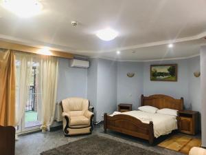 a bedroom with a bed and a chair at Red Stone in Truskavets +109 photos
