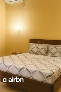a bed sitting in a room with at Affordable Spacious Apartment in Kinshasa, Limete Resit in Kinshasa