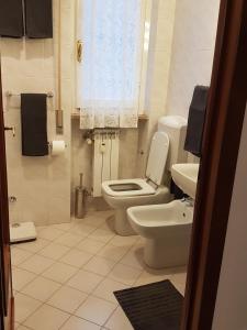 a bathroom with a toilet and a sink at Casa Marisa in Albenga +28 photos