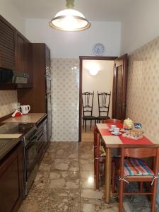 a kitchen with a table and a dining room at Casa Marisa in Albenga