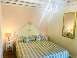 a bedroom with a bed with a striped blanket at Locazione Turistica Adriana in Vittorio Veneto +11 photos