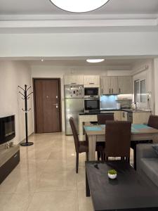 a kitchen and living room with a table and chairs at Spacious & Fully Equipped 2-Bedroom Apartment in Heraklion in Heraklio