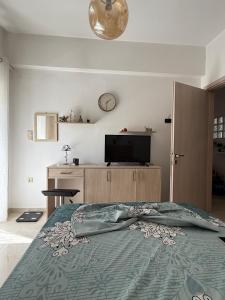a bedroom with a bed and a tv on the wall at Spacious & Fully Equipped 2-Bedroom Apartment in Heraklion in Heraklio