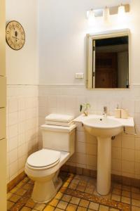 a bathroom with a toilet and a sink at Historic Loft Overlooking Plaza de Armas in Santiago +12 photos