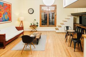 a living room with a couch and a table at Historic Loft Overlooking Plaza de Armas in Santiago