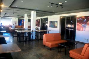 a restaurant with chairs and tables in a room at Five Clover Monastery Road in Lagos