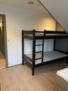 two bunk beds in a room with a staircase at Ankenes Romutleie AS in Narvik