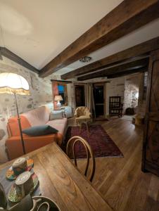 a living room with a couch and a table at La Tour du Bois Dormant in Plozévet