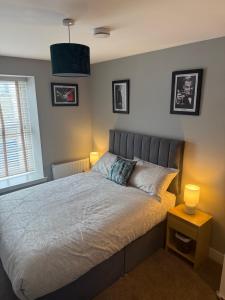a bedroom with a bed with two lamps on it at Fado apartment 1 in Bantry +5 photos