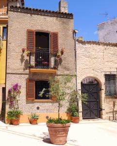 a brick building with a window and a balcony at Casa in Piazza in Vasto