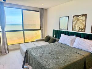 a bedroom with a bed and a large window at Flat Vista-Mar in Cabedelo