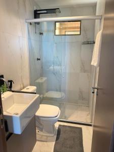 a bathroom with a shower and a toilet and a sink at Flat Vista-Mar in Cabedelo +15 photos