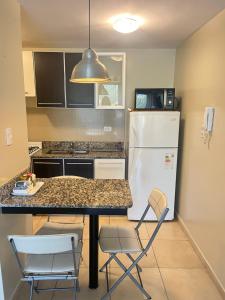 a kitchen with a refrigerator and a table and chairs at Buena Vista YB in Yerba Buena