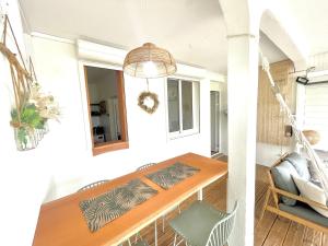 a living room with a table and a chair at La p’tite barque Antillaise in Deshaies