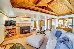 a living room with a couch and a fireplace at Oceanfront Irish Beach Home Private Beach Access! in Manchester