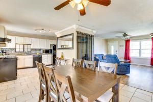 a kitchen and living room with a wooden table and chairs at 2 Mi to Fort Sill Quiet Family Retreat with Yard in Lawton