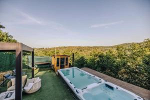 a jacuzzi tub on top of a yard at RentiGo A-Frame in Ledinci