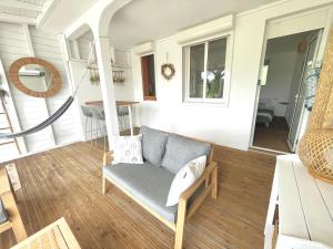 a living room with a couch in a house at La p’tite barque Antillaise in Deshaies