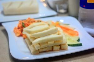 a white plate with pasta and vegetables on a table at Five Clover Monastery Road in Lagos