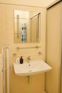 a bathroom with a sink and a mirror at Great location in the centre of Kosice in Košice