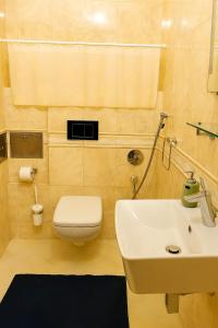 a bathroom with a white toilet and a sink at Great location in the centre of Kosice in Košice +2 photos