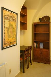 a dining room with a table and a book shelf at Great location in the centre of Kosice in Košice