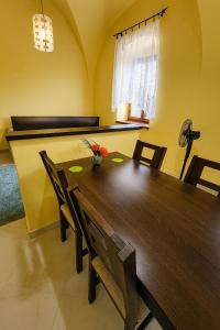 a dining room with a wooden table and chairs at Great location in the centre of Kosice in Košice