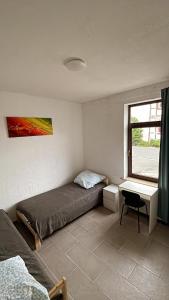 a bedroom with a bed and a window at Appartement Сoppenbrügge in Coppenbrügge