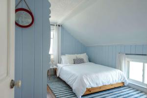 a bedroom with a white bed and a window at Stay at East Gloucester in Gloucester