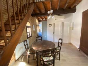 a dining room with a wooden table and chairs at Le Perchoir de Cyrano in Bergerac
