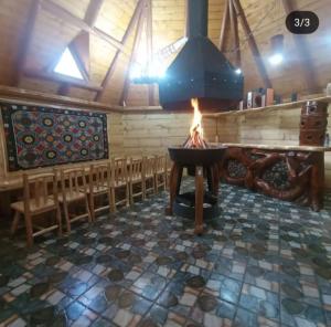 a fire pit in a church with a row of chairs at Корінь in Krasnoilov