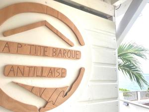 a sign on the side of a building with a turtle barcue entrance at La p’tite barque Antillaise in Deshaies +27 photos