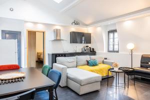 a living room with a couch and a table at La Parenthèse- Place Martroi- Vue- Clim réversible in Orléans