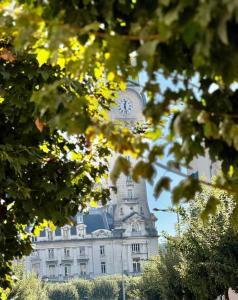 a building with a clock tower on top of it at T4 moderne parking Théodore Bac - DABNB in Limoges
