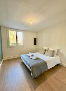 a bedroom with a large bed and a window at T4 moderne parking Théodore Bac - DABNB in Limoges