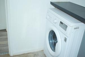 eine weiße Waschmaschine mit einer Theke darauf in der Unterkunft 3-Bedroom House Close to City Centre and M5 with Garden and Parking in Bristol + 16 Fotos