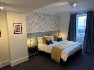 a bedroom with a large bed with a window at The Law in North Berwick