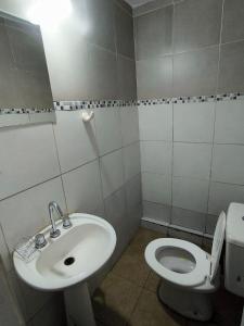 a bathroom with a sink and a toilet at Parvis Magna HOSTAL in Barraquero