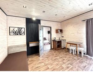 a room with a table and a desk and a bed at Inn Alibi in Kovel