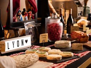 a table topped with lots of bread and bottles of wine at Mercure Lyon Centre Saxe Lafayette in Lyon