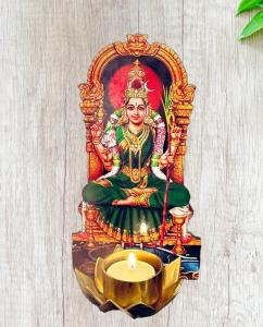 a statue of a goddess sitting next to a candle at Night Stay Guest House 8PM to 8AM Non AC and No Car Parking Near Kamatchi Amman Temple in Kanchipuram +2 photos
