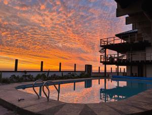 皮奇勒姆Sudeste Hostel的以日落为背景的游泳池