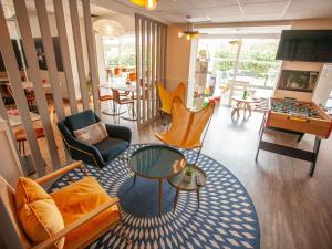 a living room filled with furniture and a table at ibis Cherbourg La Glacerie in Cherbourg en Cotentin