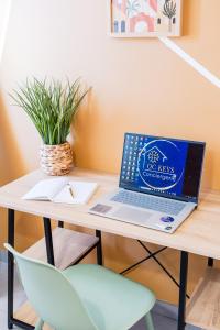 a desk with a laptop on a table with a chair at Nid confort proche du canal du midi 2 terrasses Labège in Labège