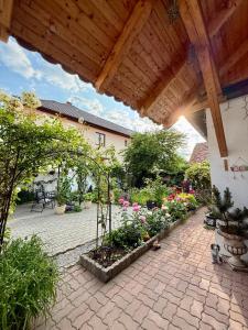 an outdoor patio with flowers and a wooden roof at Chic Home in Sibiu