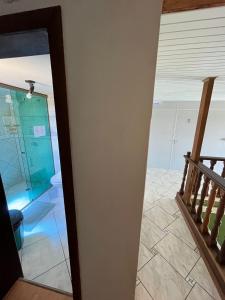 a hallway with a glass door leading into a room at Espia Mata - Pousada Hostel in Ponta Grossa +95 photos
