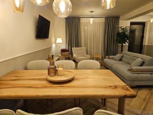 a living room with a table and a couch at RuMa Home Zarnesti in Zărneşti +13 photos
